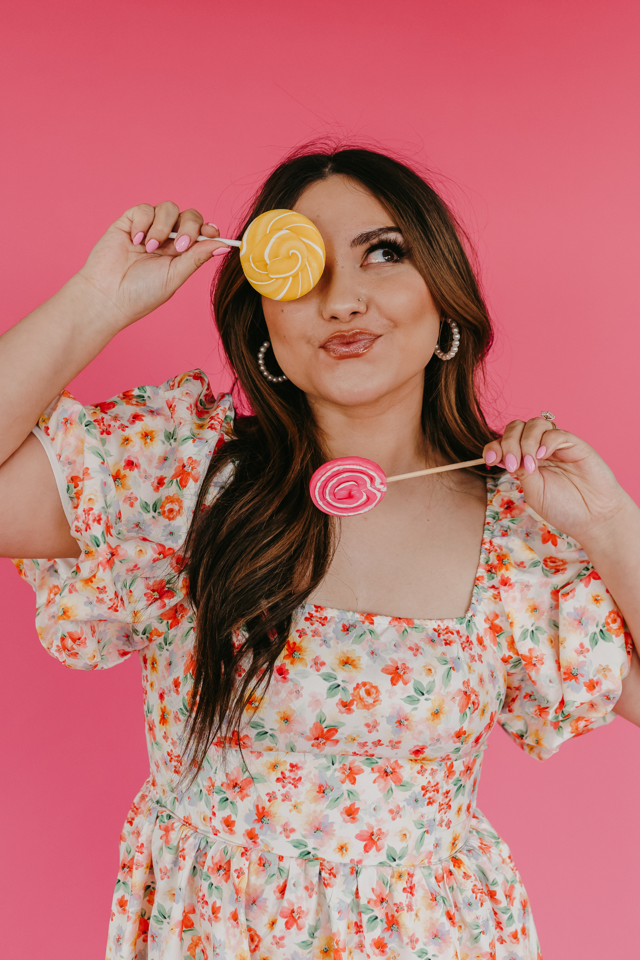 Kay Marie surrounded by florals in her signature pink aesthetic